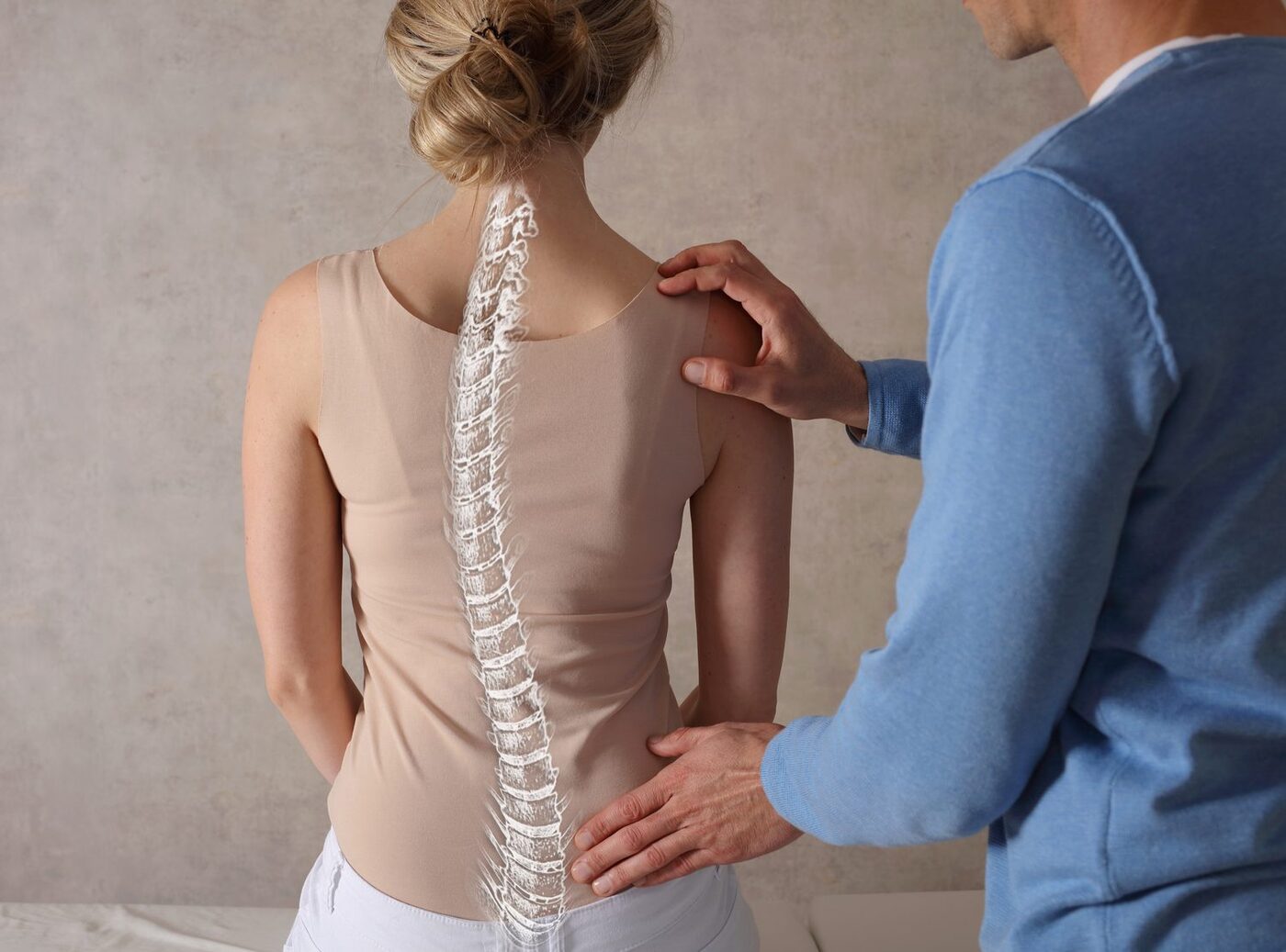 A clinician assessing a patient's back, with a spine illustration overlaid
