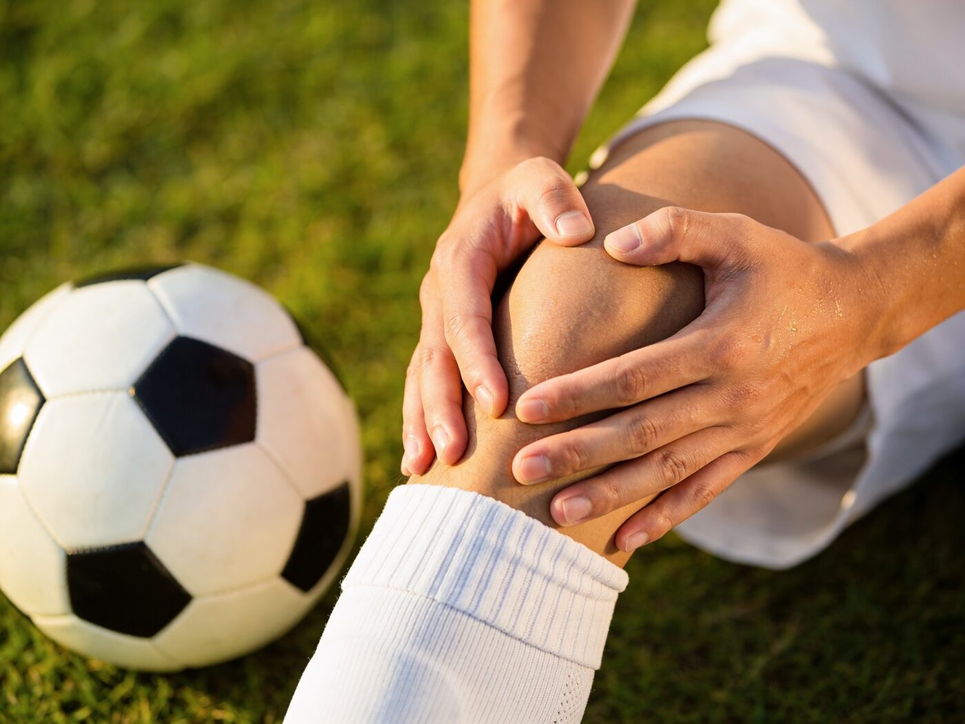 A Sports & Ortho therapist working with a field athlete on return to play