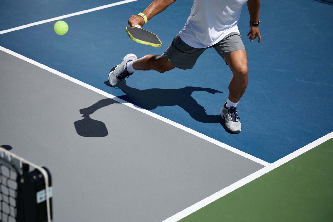A tennis or pickleball player training on court after rehab